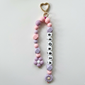 Pastel-colored keychain with 'Georgia' beads on a light gray background