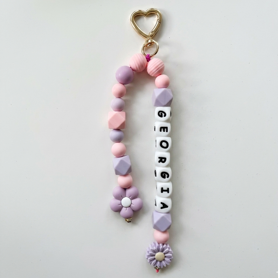 Pastel-colored keychain with 'Georgia' beads on a light gray background