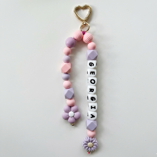Pastel-colored keychain with 'Georgia' beads on a light gray background