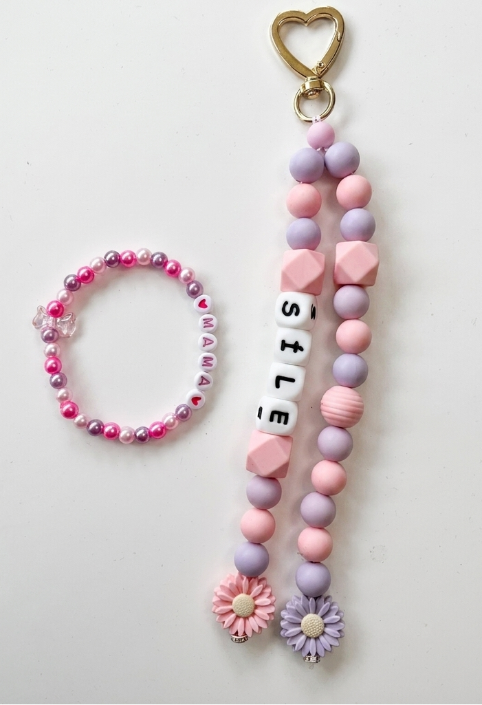 Beaded keychain and bracelet set with heart and flower charms on a white background
