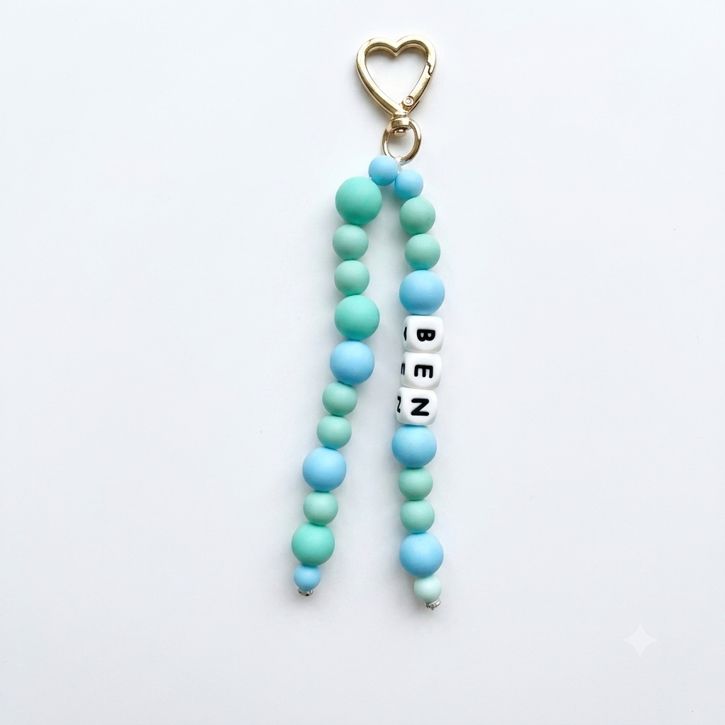 Beaded keychain with heart-shaped clasp and 'BEN' tag on a white background