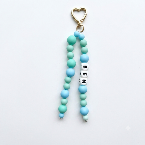 Beaded keychain with heart-shaped clasp and 'BEN' tag on a white background